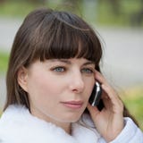 Face woman with phone and blue eyes royalty free stock photo Face woman with phone and blue eyes royalty free stock photo
