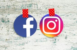 Facebook and Instagram round icons taped with red in white dots