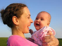 Faces mother with baby on sunset stock photo Faces mother with baby on sunset stock photo