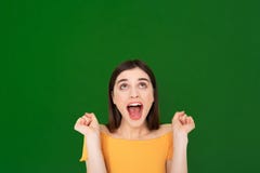 Happy excited pretty young girl isolated on green stock images Happy excited pretty young girl isolated on green stock images
