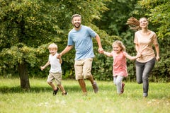 Familia que disfruta de actividades del verano en el parque Imagen de archivo libre de regalías Familia que disfruta de actividades del verano en el parque Imagen de archivo libre de regalías