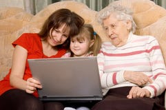 Familie op een bank met de computer royalty-vrije stock afbeeldingen Familie op een bank met de computer royalty-vrije stock afbeeldingen