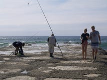 Famille à côté de pêcheur dans la plage photo libre de droits Famille à côté de pêcheur dans la plage photo libre de droits