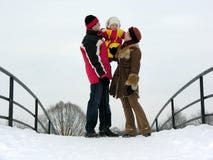 Family with baby. On winter bridge Family with baby. On winter bridge