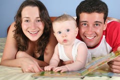 Family with baby read book
