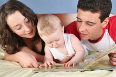Family with baby read book 2 stock photo Family with baby read book 2 stock photo