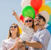 Family with balloons outdoors