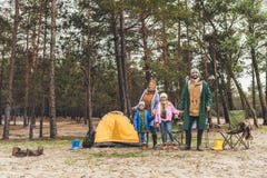 young happy family camping in forest on rainy royalty free stock photo young happy family camping in forest on rainy royalty free stock photo