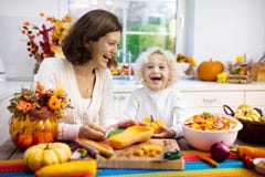 Family cooking pumpkin soup for Halloween lunch stock image Family cooking pumpkin soup for Halloween lunch stock image