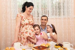 Family drinking tea in dining room, pregnant woman royalty free stock photo Family drinking tea in dining room, pregnant woman royalty free stock photo