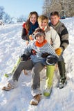 Family Enjoying Sledging Down Snowy Hill Stock Photography Family Enjoying Sledging Down Snowy Hill Stock Photography