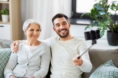 Senior mother with adult son taking selfie at home stock photography Senior mother with adult son taking selfie at home stock photography