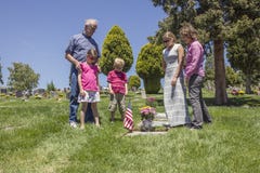 Family grieving together at a grave in a cemetery royalty free stock photos Family grieving together at a grave in a cemetery royalty free stock photos