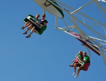 Family having fun on the paratrooper fairground ride.