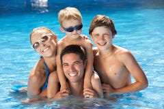 Family Having Fun In Swimming Pool