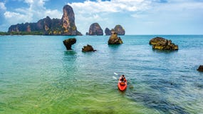 Family kayaking, mother and daughter paddling in kayak on tropical sea canoe tour near islands, having fun, active vacation stock photos Family kayaking, mother and daughter paddling in kayak on tropical sea canoe tour near islands, having fun, active vacation stock photos