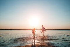 Family on the lake against a beautiful sunset. A happy life, happiness, family vacations. stock image Family on the lake against a beautiful sunset. A happy life, happiness, family vacations. stock image