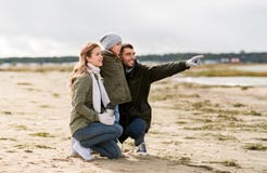 Happy family on autumn beach stock photos Happy family on autumn beach stock photos