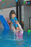Family of mother teaching baby in swimming pool royalty free stock photo Family of mother teaching baby in swimming pool royalty free stock photo