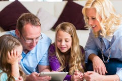 Family playing with Tablet computer at home Stock Photos Family playing with Tablet computer at home Stock Photos
