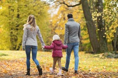 Happy family walking at autumn park Royalty Free Stock Photography Happy family walking at autumn park Royalty Free Stock Photography