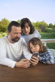 Family shopping online via the terrace on a summer evening Stock Photo Family shopping online via the terrace on a summer evening Stock Photo