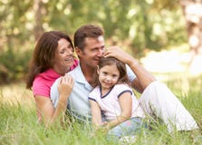 Family Sitting In Park Stock Photo Family Sitting In Park Stock Photo
