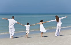 Family Walking & Holding Hands On Beach Family Walking & Holding Hands On Beach