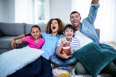 Family watching american football match on television