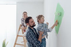 Família que pinta uma sala junto fotos de stock Família que pinta uma sala junto fotos de stock
