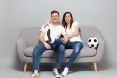 Fan de futebol alegres do homem da mulher dos pares na equipe favorita do t-shirt do elogio do apoio branco acima com a língua da fotografia de stock Fan de futebol alegres do homem da mulher dos pares na equipe favorita do t-shirt do elogio do apoio branco acima com a língua da fotografia de stock