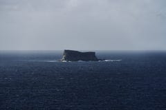 Far little island among the sea royalty free stock photography Far little island among the sea royalty free stock photography