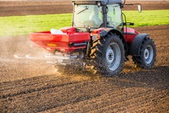 Farmer fertilizing arable land with nitrogen, phosphorus, potassium fertilizer stock image Farmer fertilizing arable land with nitrogen, phosphorus, potassium fertilizer stock image