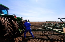 Farmer Fixing A Tractor Royalty Free Stock Photo Farmer Fixing A Tractor Royalty Free Stock Photo