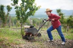 Farmer at work ploughing virgin soil