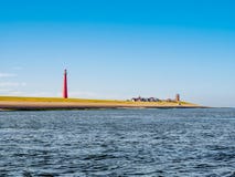 Faro Lange Jaap alla costa del Mare del Nord, Huisduinen, Den Helder, Paesi Bassi fotografia stock Faro Lange Jaap alla costa del Mare del Nord, Huisduinen, Den Helder, Paesi Bassi fotografia stock