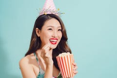 Fashion asian woman drinks coke bottle over blue background. Royalty Free Stock Images Fashion asian woman drinks coke bottle over blue background. Royalty Free Stock Images