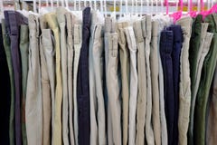 A row of many men`s pants hanging on a clothes rank and selling in a shop royalty free stock photos A row of many men`s pants hanging on a clothes rank and selling in a shop royalty free stock photos