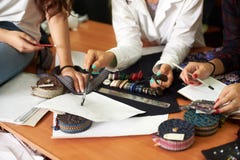 Fashion designer female team working on clothes creation, choosing accessories, discussing sketches. stock photography Fashion designer female team working on clothes creation, choosing accessories, discussing sketches. stock photography