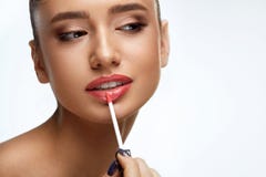Fashion Female Model With Beauty Face Applying Lip Balm On Lips stock images Fashion Female Model With Beauty Face Applying Lip Balm On Lips stock images