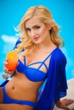 Fashion outdoor photo of beautiful sensual woman wearing elegant bikini, posing beside swimming pool with cocktail. royalty free stock photos Fashion outdoor photo of beautiful sensual woman wearing elegant bikini, posing beside swimming pool with cocktail. royalty free stock photos