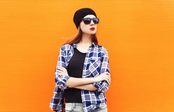 Fashion pretty woman wearing a black hat, sunglasses and checkered shirt over colorful. Background Royalty Free Stock Photos Fashion pretty woman wearing a black hat, sunglasses and checkered shirt over colorful. Background Royalty Free Stock Photos