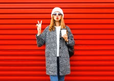 Fashion Pretty Woman With Coffee Cup In Coat Posing On Red Royalty Free Stock Images Fashion Pretty Woman With Coffee Cup In Coat Posing On Red Royalty Free Stock Images