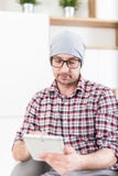 Fashionable architect or executive holding tablet device at his office stock photography Fashionable architect or executive holding tablet device at his office stock photography