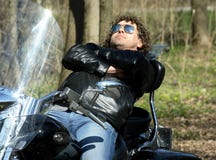 Fashionable Biker Relax Sitting On His Motorcycle Fashionable Biker Relax Sitting On His Motorcycle