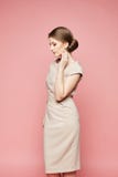 Fashionable Brunette Model, Beautiful Woman With Stylish Hairstyle In Beige Trendy Dress Posing With Closed Eyes At Pink Stock Images