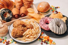 Fast food and unhealthy eating concept - close up of fast food snacks and cola drink on white table stock image Fast food and unhealthy eating concept - close up of fast food snacks and cola drink on white table stock image