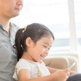 Father and child using digital tablet. Stock Photo Father and child using digital tablet. Stock Photo