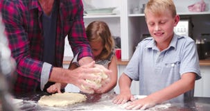 Father And Children Making Pizza In Kitchen Together stock video footage Father And Children Making Pizza In Kitchen Together stock video footage