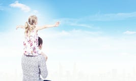Father and daughter. Little daughter sitting on father's shoulders. Parenting concept royalty free stock photography Father and daughter. Little daughter sitting on father's shoulders. Parenting concept royalty free stock photography